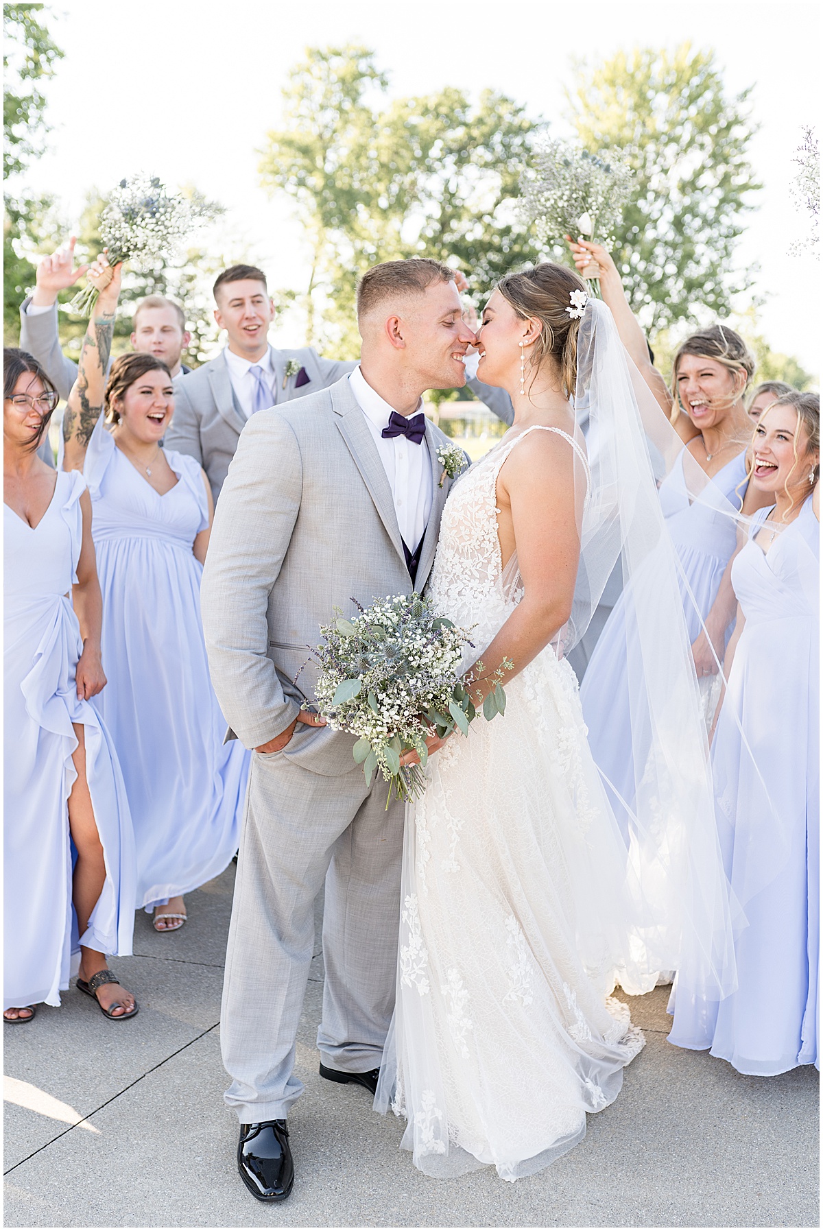 Bridal party celebrates couple kissing after White Willow Creek Barn wedding in Frankfort, Indiana