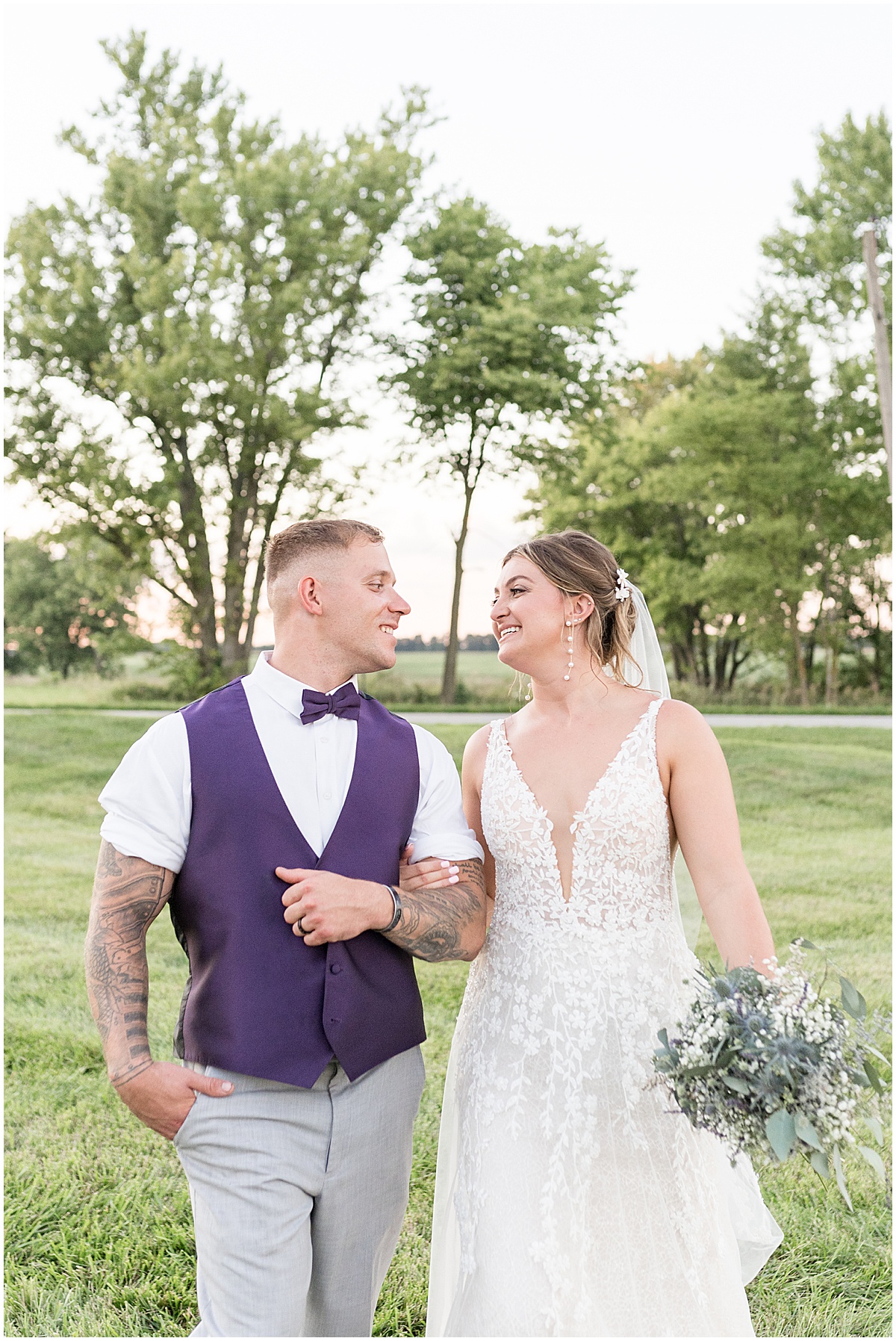 Couple walk at sunset after White Willow Creek Barn wedding in Frankfort, Indiana