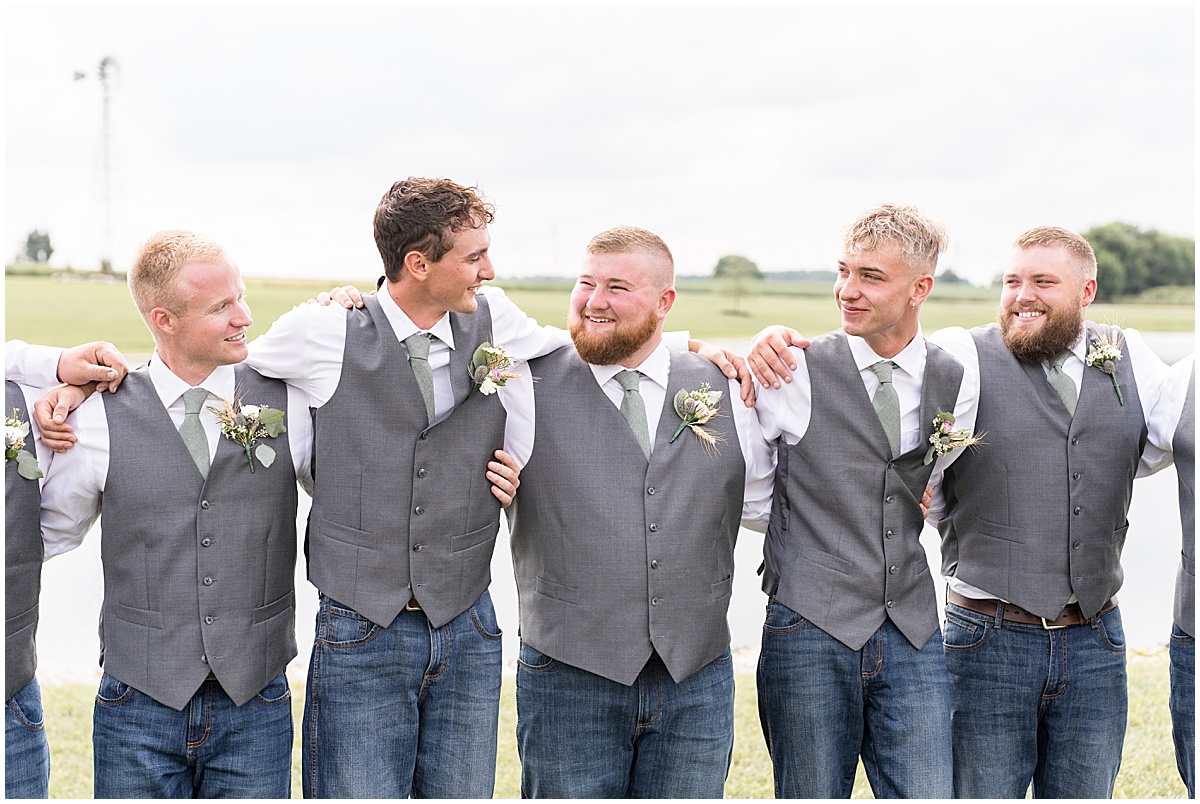 Groom with groomsmen in green tie and vest before private property wedding in Peru, Indiana