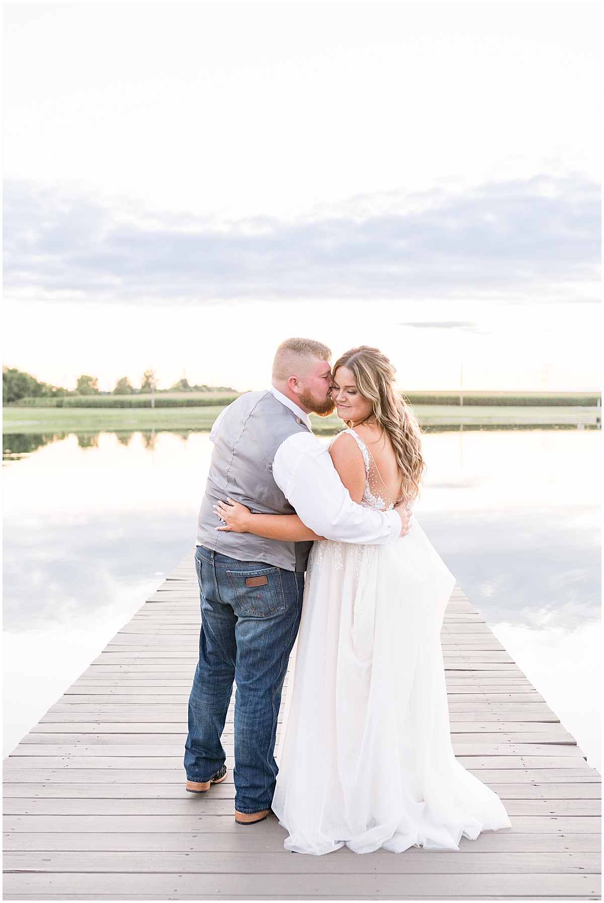 Newlyweds kiss on dock after private property wedding in Peru, Indiana