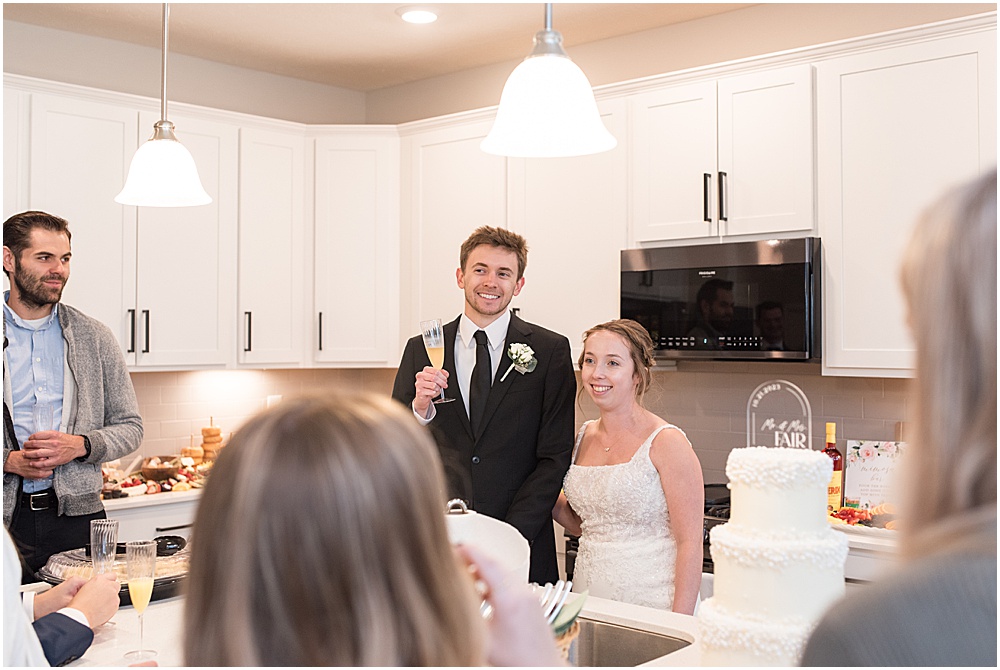 Bride and groom welcoming guests to at-home, brunch wedding in Westfield, Indiana