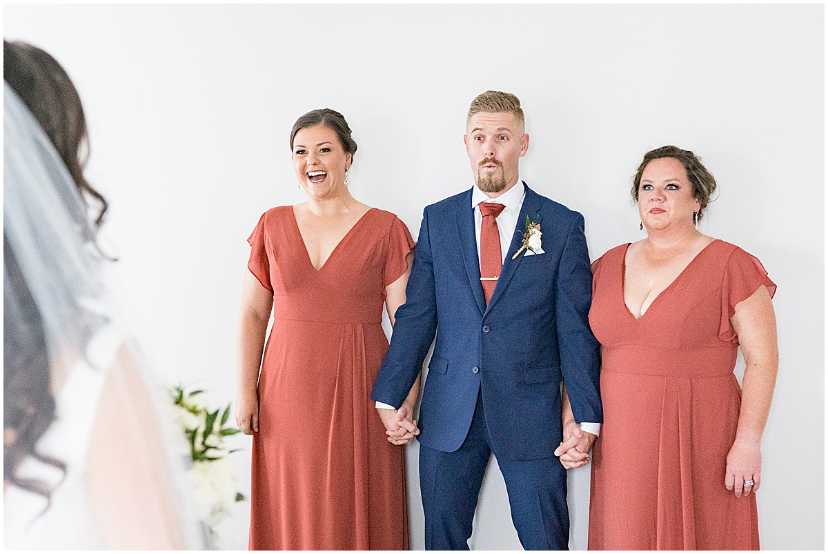 Bridesmaids reaction to bride at Lighthouse Restaurant wedding in Cedar Lake, Indiana