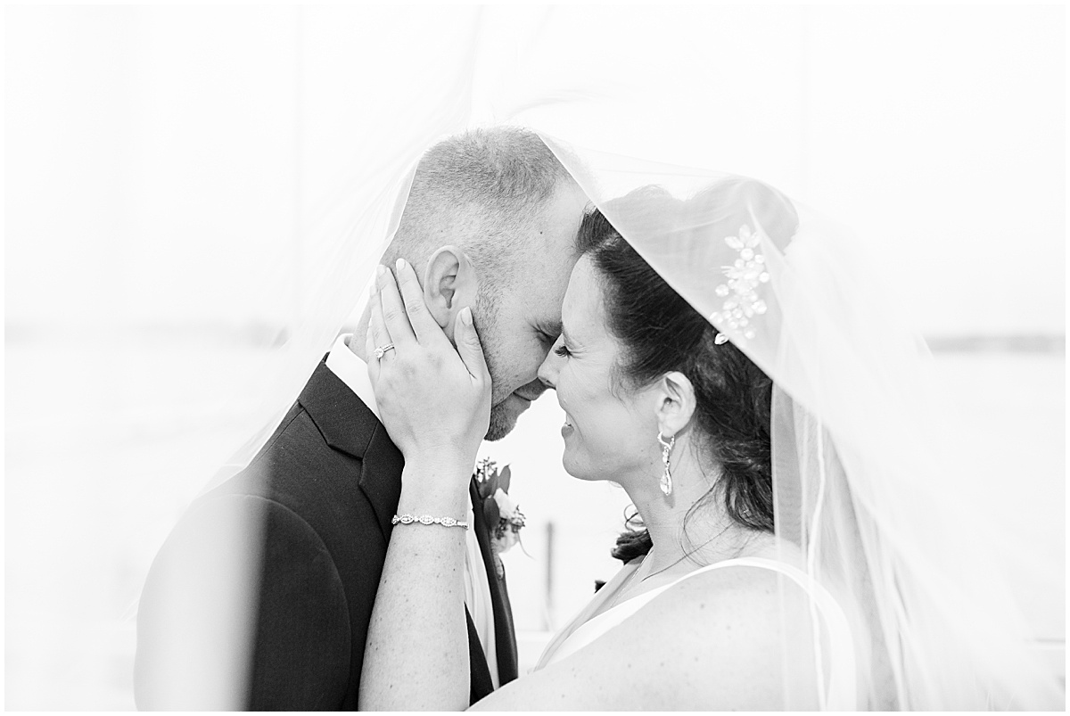 Kissing under veil at Lighthouse Restaurant wedding in Cedar Lake, Indiana