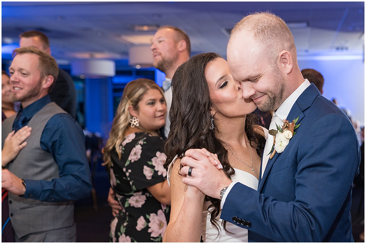 Bride kisses groom on dance floor at Lighthouse Restaurant wedding in Cedar Lake, Indiana