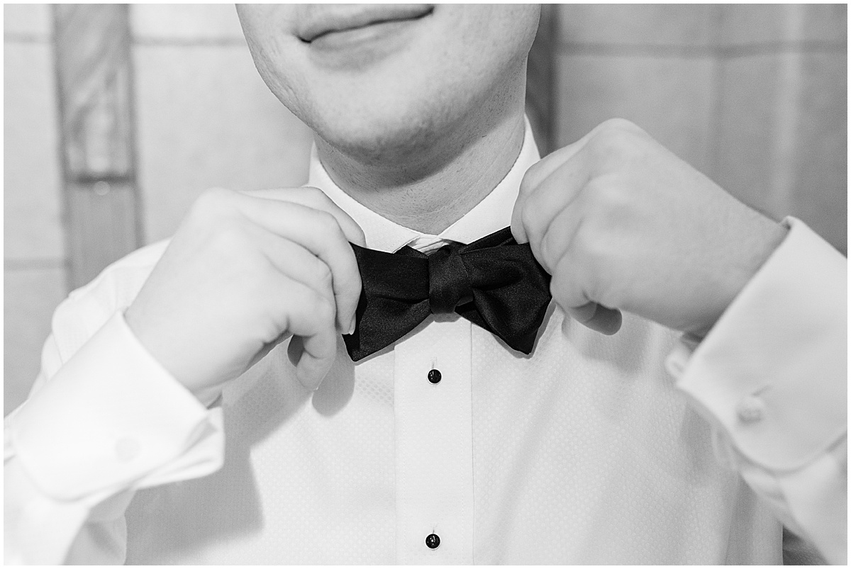 Groom adjusting bowtie before Union Station Illinois Street Ballroom wedding in downtown Indianapolis