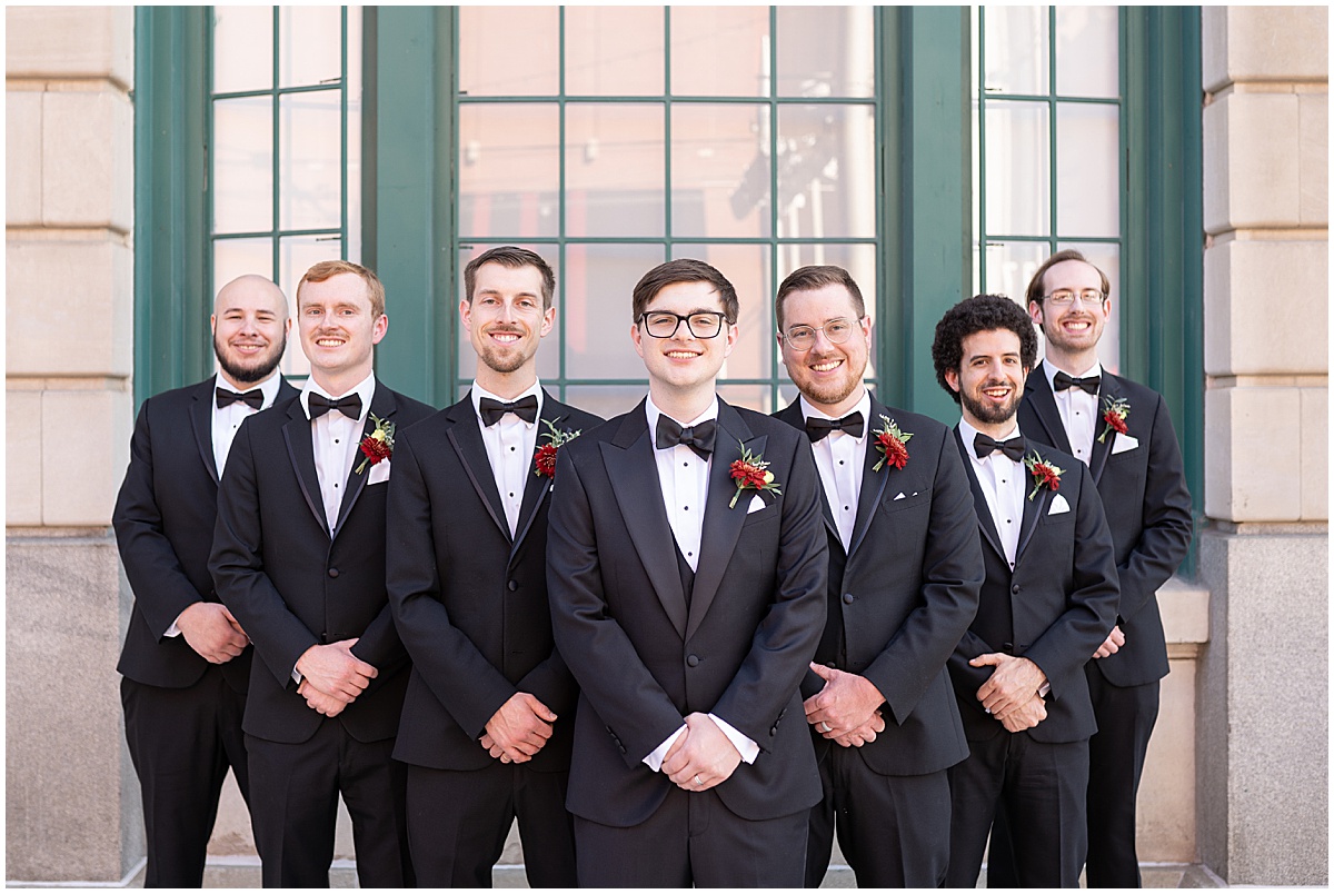 Groom with groomsmen in black tuxes in downtown Indianapolis