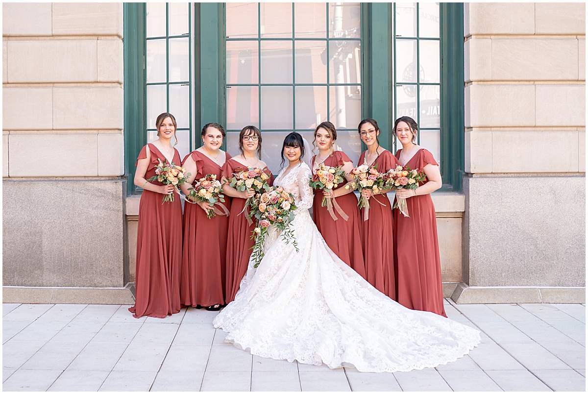 Bride shows off full dress train during photos in downtown Indianapolis