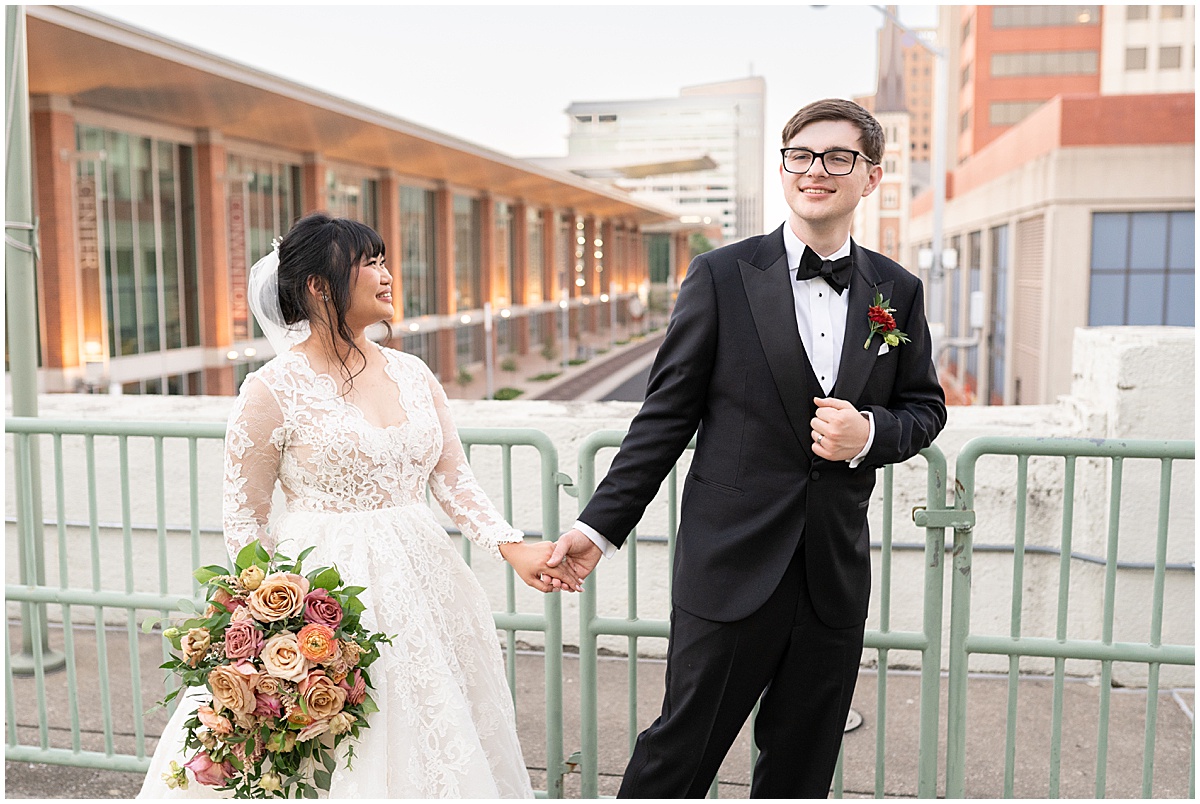 Bride and groom walk on bridge at Union Station Illinois Street Ballroom wedding in downtown Indianapolis