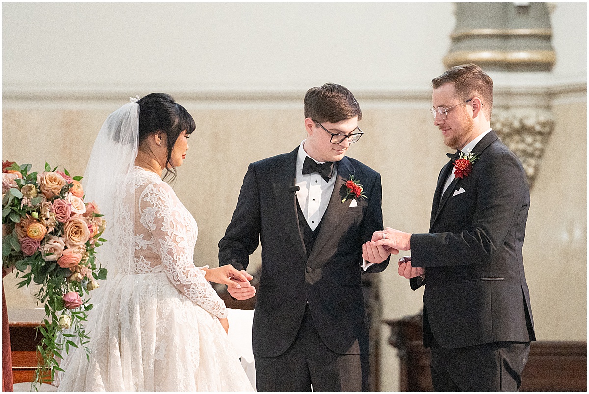 Groom gets ring during wedding at Saint John the Evangelist Church in downtown Indianapolis
